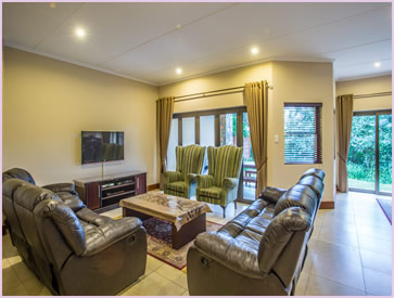 The lounge at Zimbali Holiday Home's Baluwatu villa has luxury leather recliner couches and a high definition 3D TV with DSTV