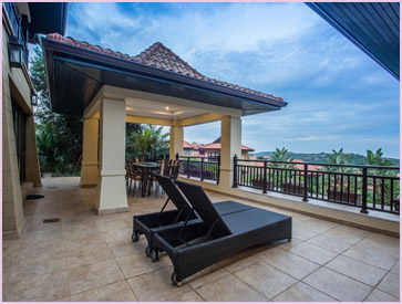 Covered balcony area in the frontyard of Zimbali Holiday Home's Acaciawood villa, which has a beautiful view of the Indian Ocean